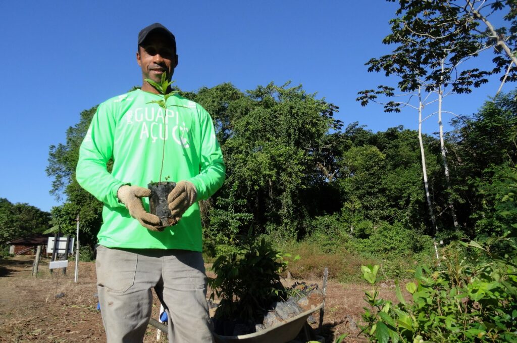 Mauricio Noqueira holding a sapling at REGUA, Brazil.